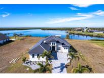 Luxury waterfront home with a tile roof and paver driveway at 5061 Collingswood Blvd, Port Charlotte, FL 33948