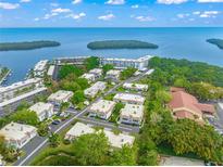 Aerial view of waterfront community with lush landscaping and multiple buildings at 542 Sutton Pl, Longboat Key, FL 34228