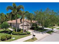 Single-story home with landscaped yard, attached garage, and palm trees at 8047 Victoria Falls Cir, Sarasota, FL 34243