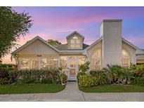 Inviting coastal cottage with landscaped front yard, charming details, and a two-car garage at 4629 Whirlaway Dr # B, Sarasota, FL 34233