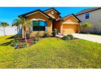 Attractive single-story house with a two-car garage and landscaped lawn at 3920 Willow Walk Dr, Palmetto, FL 34221