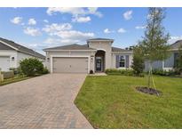 Attractive single-story house with a two-car garage and landscaped lawn at 5307 Cappleman Loop, Brooksville, FL 34601