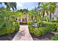 Lush landscaping, a fountain, and brick pathways enhance this inviting community courtyard at 4264 Central Sarasota Pkwy # 116, Sarasota, FL 34238