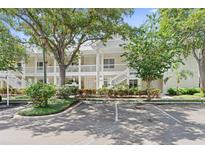 Two-story condo building with white exterior, balconies, and landscaping at 3702 54Th W Dr # 102, Bradenton, FL 34210