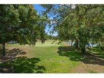 Scenic golf course view framed by lush trees at 6736 Fairview Ter # 6736, Bradenton, FL 34203