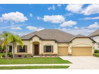 Single-story home with two-car garage, landscaping, and palm tree at 6309 75Th E Ave, Palmetto, FL 34221