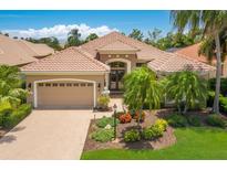 Charming single-story home featuring a tile roof, landscaped yard and brick-paved driveway at 7167 Whitemarsh Cir, Lakewood Ranch, FL 34202