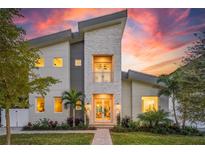 Stunning modern home with light stone and gray exterior at sunset at 2446 Floyd St, Sarasota, FL 34239