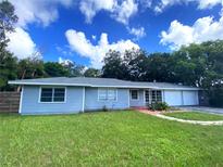 Gray house with a green lawn and a two-car garage at 2825 Sequoia Ln, Sarasota, FL 34237