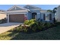 Newly constructed home with a two-car garage and well-manicured landscaping at 5415 Limelight Dr, Apollo Beach, FL 33572