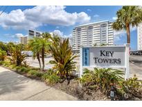 Key Towers building sign with landscaping and parking lot at 1750 Benjamin Franklin Dr # 2G, Sarasota, FL 34236