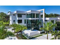 Modern white two-story home with a sleek design and palm trees at 1610 N Lodge Dr, Sarasota, FL 34239