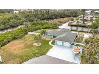 Cute waterfront home with three-car garage and boat parking at 613 Elba Dr, Nokomis, FL 34275