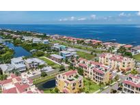 Expansive aerial view of a waterfront community with a beautiful home near a canal and the ocean at 1450 Silvia Shores Dr, Apollo Beach, FL 33572