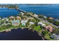 Aerial view of waterfront home with pool and private dock at 1502 Siesta Dr, Sarasota, FL 34239