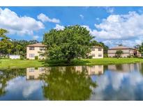 Building exterior with pond view and lush landscaping at 5026 Water Oak Dr # 112, Bradenton, FL 34207