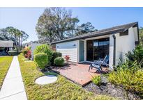 Exterior view of condo with patio and landscaping at 3531 Longmeadow # 16, Sarasota, FL 34235