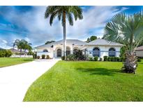 Beautiful single-story home with a three-car garage and lush landscaping at 15923 29Th E St, Parrish, FL 34219