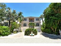 Two-story house with a light peach exterior, two-car garage, and landscaping at 4931 Oxford Dr, Sarasota, FL 34242