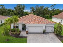 Two-car garage, paver driveway, and tile roof at 7291 Great Egret Blvd, Sarasota, FL 34241