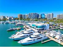 Aerial view of a waterfront community with luxury yachts and high rise buildings at 1155 N Gulfstream Ave # 208, Sarasota, FL 34236