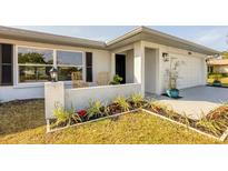 Updated home exterior boasts a modern design, landscaping, and driveway at 2806 67Th W St, Bradenton, FL 34209