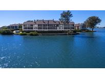 Aerial view of waterfront condo building with lush landscaping at 3825 Mariners Walk # 622, Cortez, FL 34215
