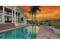 Inviting pool area with patio furniture, offering sunset views at 495 Mckinley Dr, Sarasota, FL 34236