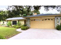 Ranch-style home with attached garage and mature landscaping at 7607 9Th Avenue Nw Dr, Bradenton, FL 34209