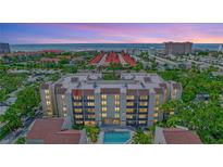 Aerial view of a condo building near the beach with a pool at 6157 Midnight Pass Rd # E65, Sarasota, FL 34242