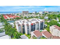 Aerial view of condo building near beach and water at 6157 Midnight Pass Rd # E65, Sarasota, FL 34242