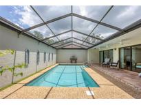 Enjoy a covered private pool with ample seating and easy access to indoor living spaces at 3902 Glen Oaks Manor Dr, Sarasota, FL 34232