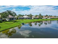 Aerial view of home showcasing a lakefront location and lush landscaping at 4043 Caddie E Dr, Bradenton, FL 34203