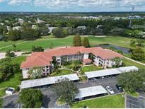 Aerial view of condo community near golf course with covered parking at 6503 Stone River Rd # 302, Bradenton, FL 34203