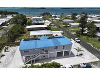 Elevated view of waterfront home with solar panels, showcasing its unique design and location at 4507 106Th W St, Bradenton, FL 34210