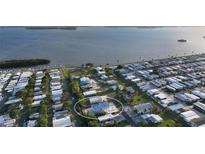 Aerial view of waterfront property, showcasing a modern home and surrounding community at 4507 106Th W St, Bradenton, FL 34210