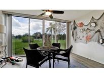 Sunroom with wicker furniture and view of the golf course at 4480 Fairways Blvd # 109, Bradenton, FL 34209