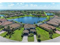 Luxury home with lakefront lot, paver driveway and lush landscaping at 14118 Florida Rosemary Dr, Bradenton, FL 34211