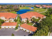 Aerial view of condo community near golf course and lake at 7187 Boca Grove Pl # 202, Lakewood Ranch, FL 34202