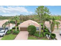 Single-story home with attached garage and manicured lawn at 115 Winding River Trl, Bradenton, FL 34212