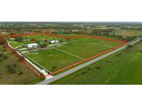 Aerial view of expansive property with main house, guesthouse, and horse stable at 3630 Verna Rd, Myakka City, FL 34251