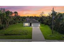 New construction home with a two-car garage and a driveway at 1800 S San Mateo Dr, North Port, FL 34288