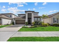 Two-story house with a two-car garage and landscaped front yard at 3512 Hidden Creek Blvd, Sarasota, FL 34240