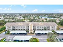 Aerial view of condo building with parking and surrounding landscape at 7201 29Th Avenue W Dr # 306, Bradenton, FL 34209