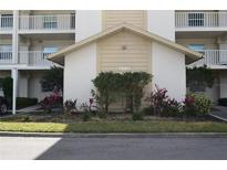 Exterior view of condo building, showing landscaping and building number 7201 at 7201 29Th Avenue W Dr # 306, Bradenton, FL 34209