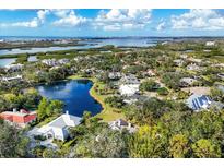 Aerial view of upscale community with water features and lush landscaping at 75 Osprey Point Dr, Osprey, FL 34229