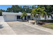 Newly renovated home with a spacious driveway and palm trees at 1809 Southwood St, Sarasota, FL 34231