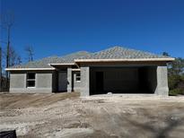 New construction home with gray siding and a two-car garage at 5085 Raven St, North Port, FL 34286