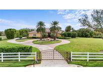 Beautiful two-story home with circular driveway and lush landscaping at 8480 Big Buck Ln, Sarasota, FL 34240