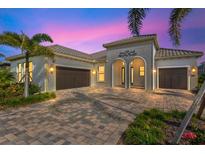 Stunning two-story home with a three-car garage and paver driveway at 333 Bocelli Dr, Nokomis, FL 34275